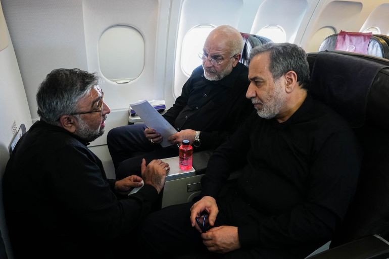 This handout picture released by the office of the Speaker of the Iranian Parliament shows Iranian Parliament Speaker and Iran negotiating team head Mohammad Bagher Ghalibaf (C) and Iranian Foreign Minister Abbas Araghchi (R) speaking with a member of the Iranian delegation aboard a flight en route to Zurich on June 21, 2026.